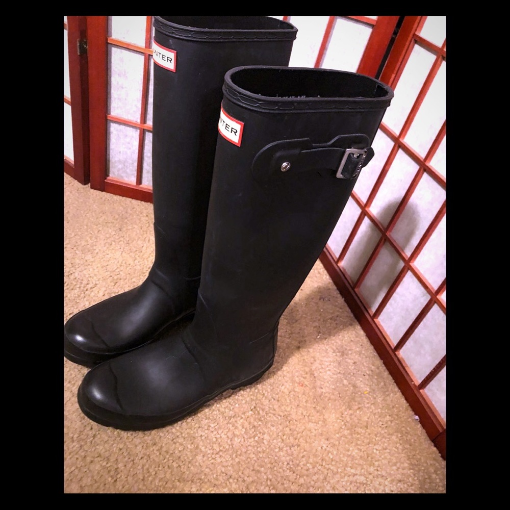 Lightly worn matte black Hunter boots.